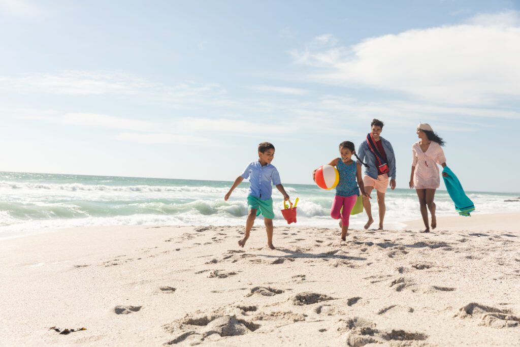 Family walking together on beach - one of the best things to do in Myrtle Beach in Spring  